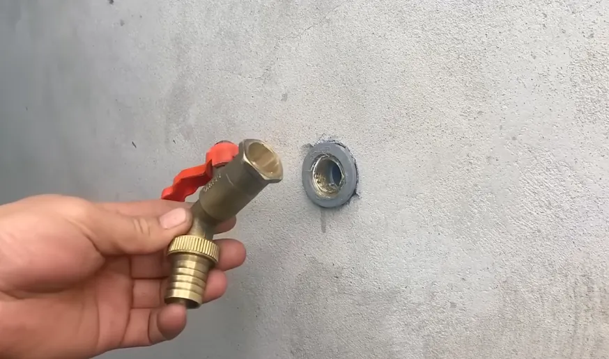 Brass valve fitting ready to install on a wall supply pipe, the kind of plumbing work covered by Truckee permits