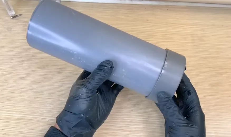Gloved hands joining sections of PVC sewer pipe for a sewer lateral replacement at Donner Lake